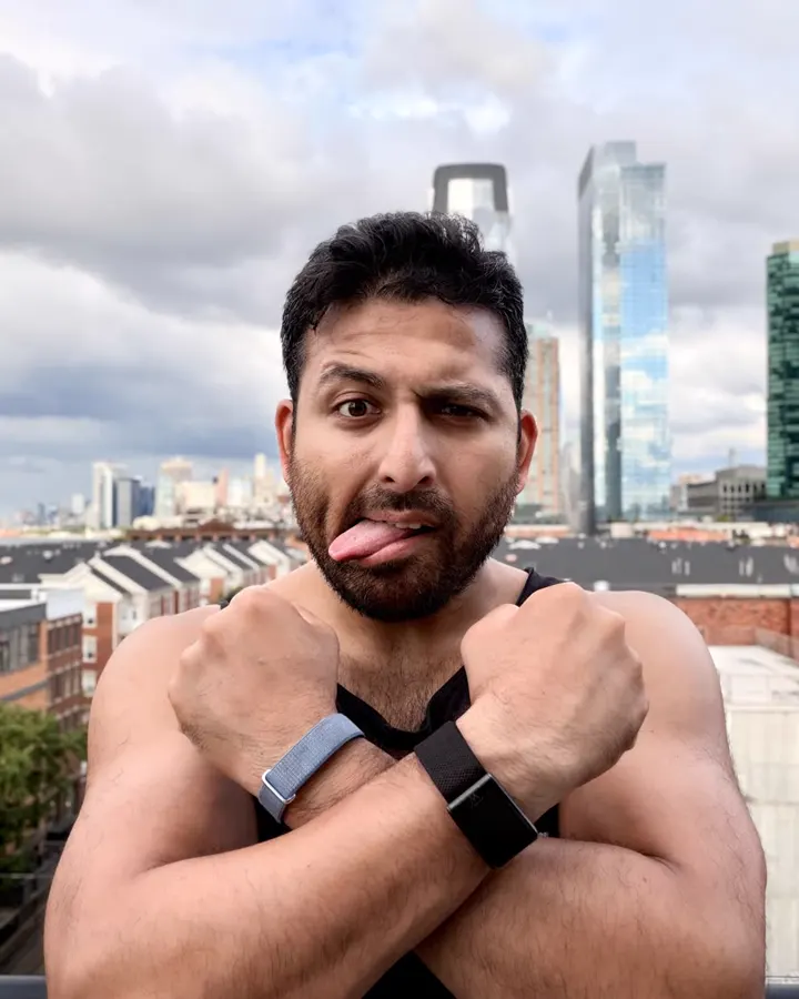 Arnab, Hangry's founder, tongue out, arms crossed, a fitness band on each wrist